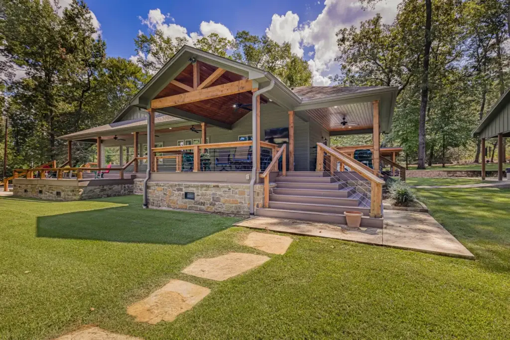 Rebuilt Fern Lake house in Marshall, TX, with a covered back porch, timber gable and stone skirting