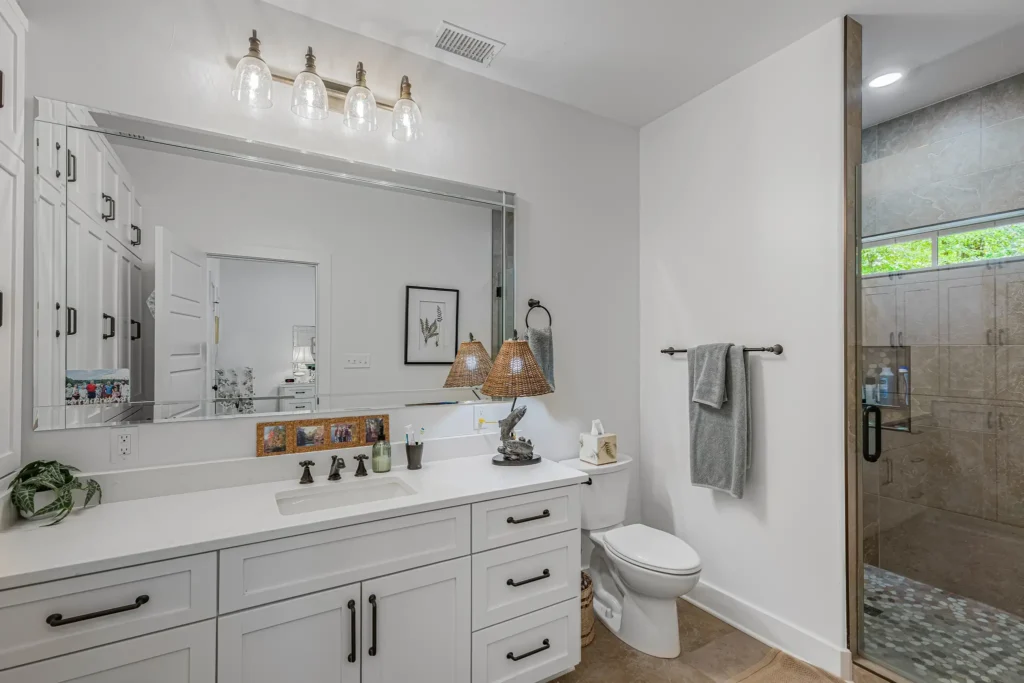 Bathroom with a double vanity and a tiled walk-in shower