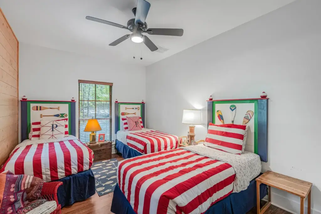 Guest bedroom with twin beds and a pine accent wall