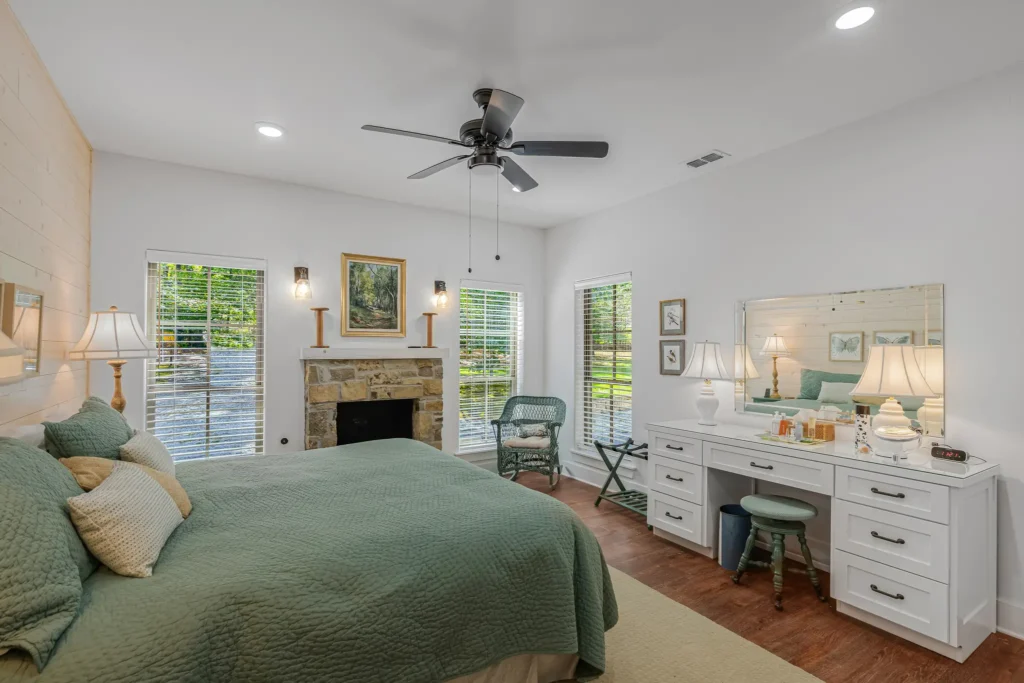 Primary bedroom with a gas fireplace and a built-in vanity
